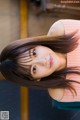 A woman with long brown hair is posing for a picture.